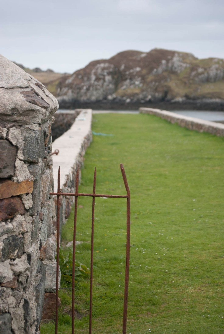 The depth of field in this photo is not large enough. Although the gate is the main focus, the lines lead you to the background which is out of focus. This leads to a confusing photograph.
